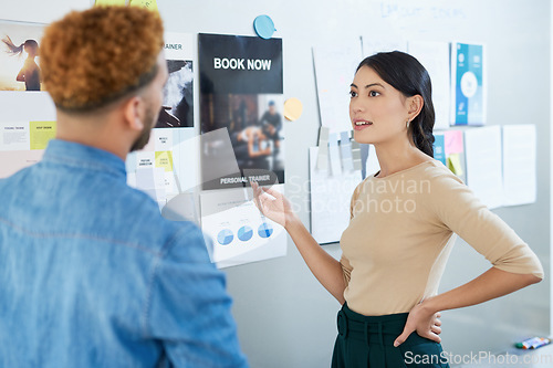 Image of Business is about keeping an eye on your competitors too. a young businesswoman having a discussion with a colleague in an office.