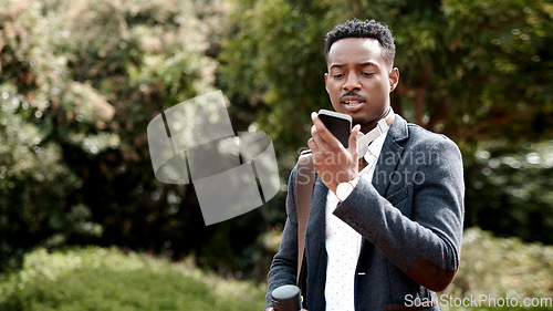 Image of Nothing keeps you connected to clients like open communication. a young businessman using a smartphone against an urban background.