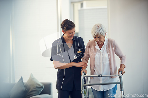 Image of Youre doing so great. a young nurse assisting a senior woman walk using a walker in a nursing home.