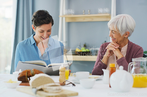 Image of Should we try this recipe next. a happy senior woman sitting and having breakfast with her attractive young daughter while at home.