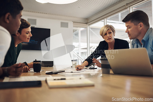 Image of Lets talk it over. a group of business colleagues sitting around a table in the boardroom during a meeting.