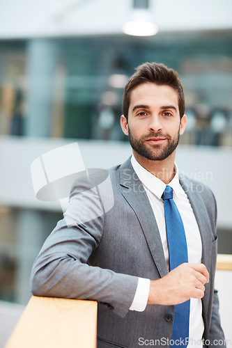 Image of Bring excellence to every move you make. Portrait of a confident young businessman standing in an office.