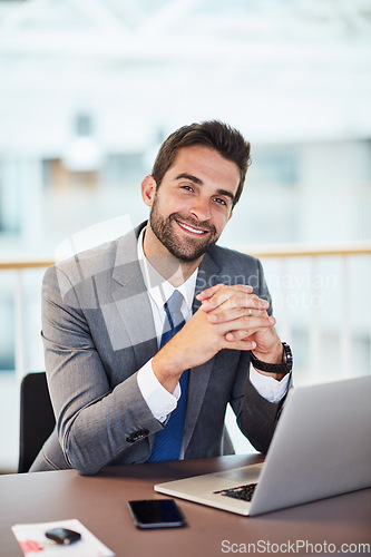 Image of Hard work is so vital to ensuring success. Portrait of a young businessman working on a laptop in an office.