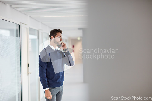 Image of This is something we should talk about face-to-face. a young businessman talking on a cellphone in an office.