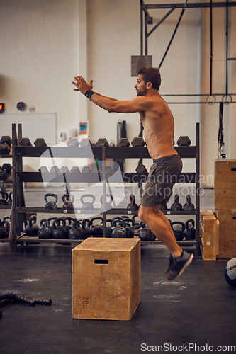 Image of Jumping just got a little tougher. Full length shot of a handsome young man box jumping while working out in the gym.