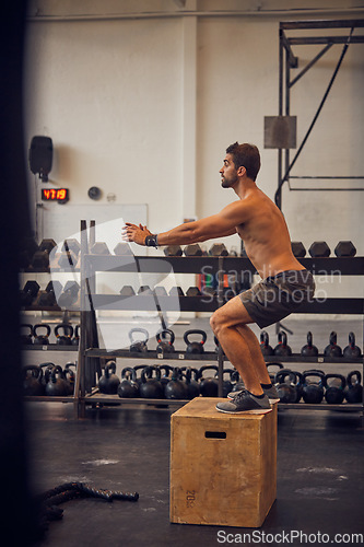 Image of Its about maintaining proper form. Full length shot of a handsome young man box jumping while working out in the gym.