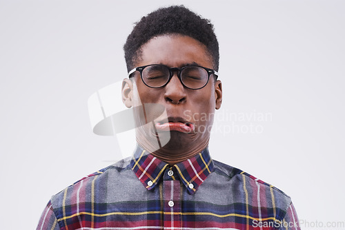 Image of Because life would be boring without a bit of fun. Studio shot of a young man making a funny face against a gray background.