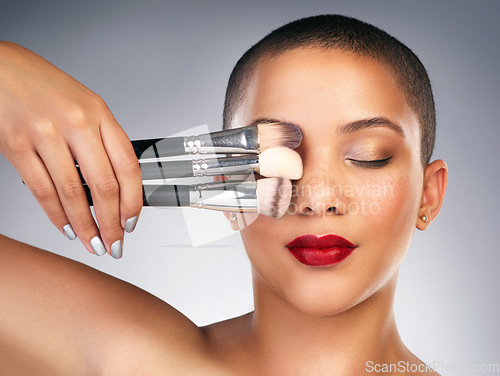 Image of Never brush in a rush. Studio shot of a beautiful young woman posing with a set of makeup brushes.