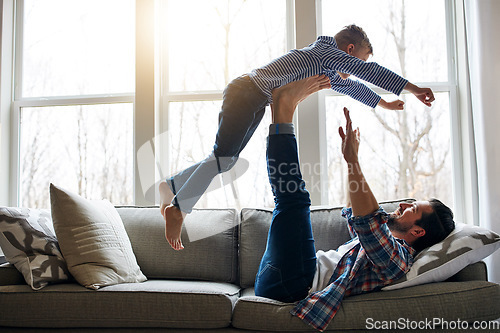 Image of Its turning out to be a fun-filled day. a father and his little son having fun at home.