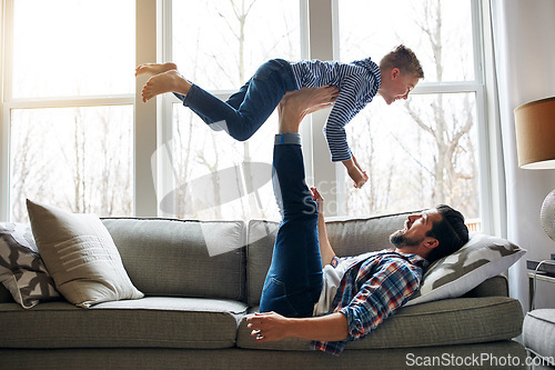 Image of Im the king of the world. a father and his little son having fun at home.