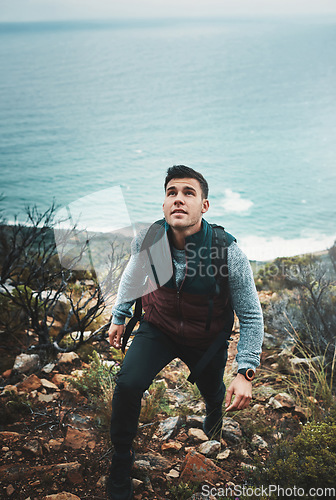 Image of You wont find new paths unless you wander. a young man hiking through the mountains.
