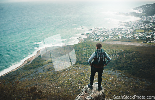 Image of Roam far and wander wide. a young man looking at the view from a cliff while out on a hike.