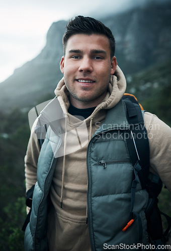 Image of Seeking adventure is always on my to-do list. Portrait of a young man hiking through the mountains.