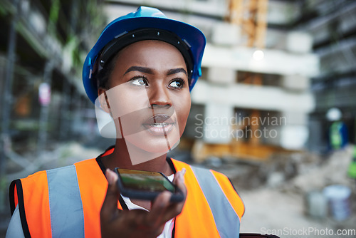 Image of Leveraging new technology for large scale construction. a young woman using a smartphone while working at a construction site.