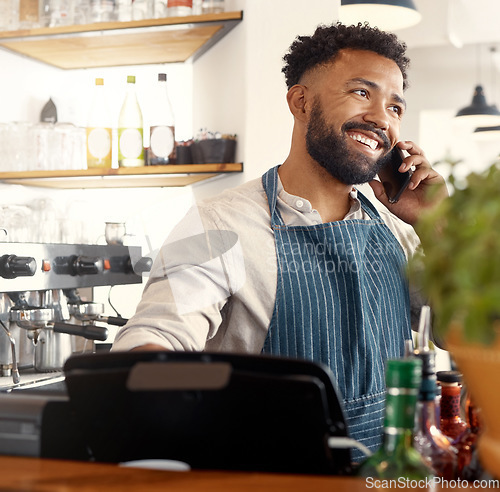 Image of Placing orders has never been easier. a young waiter taking an order via his smartphone.