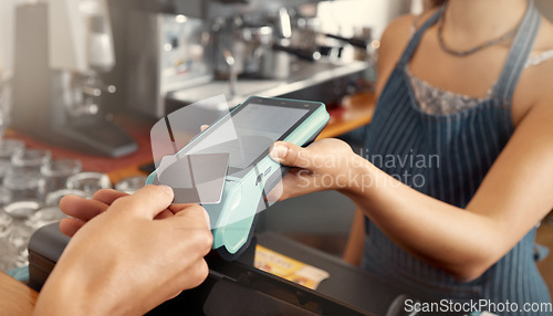 Image of Making businesses run smoother. a customer using a nfc machine to make a card payment at a restaurant.