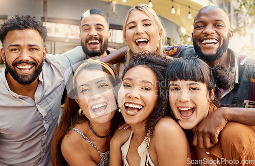 Image of Special times with incredible people. a group of young friends taking selfies together at a restaurant.