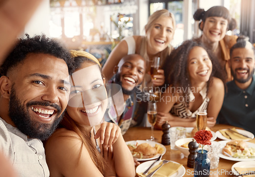Image of The best people to have around. a group of young friends taking selfies together at a restaurant.