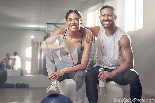 Image of Hit the gym and bring your partner along. two young athletes sitting together at the gym.