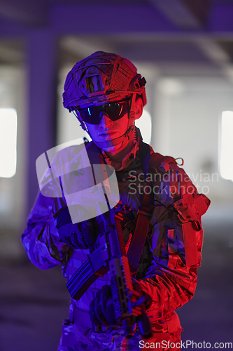 Image of A professional soldier undertakes a perilous mission in an abandoned building illuminated by neon blue and purple lights