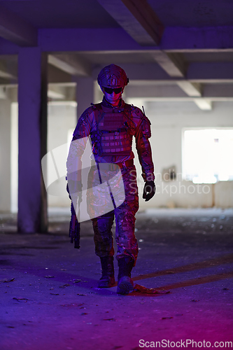 Image of A professional soldier undertakes a perilous mission in an abandoned building illuminated by neon blue and purple lights