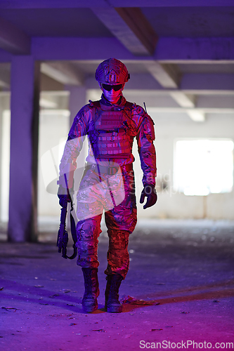 Image of A professional soldier undertakes a perilous mission in an abandoned building illuminated by neon blue and purple lights