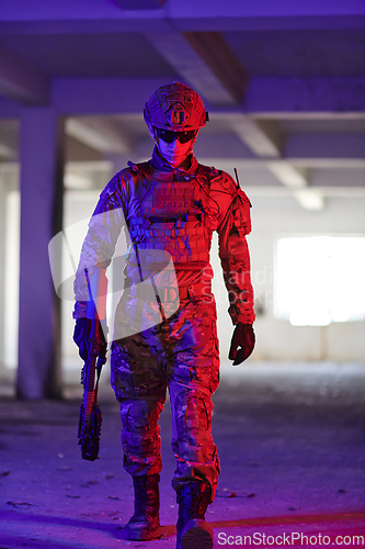 Image of A professional soldier undertakes a perilous mission in an abandoned building illuminated by neon blue and purple lights