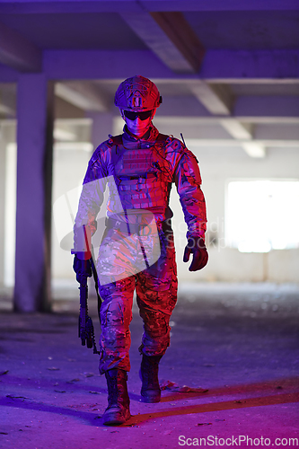 Image of A professional soldier undertakes a perilous mission in an abandoned building illuminated by neon blue and purple lights