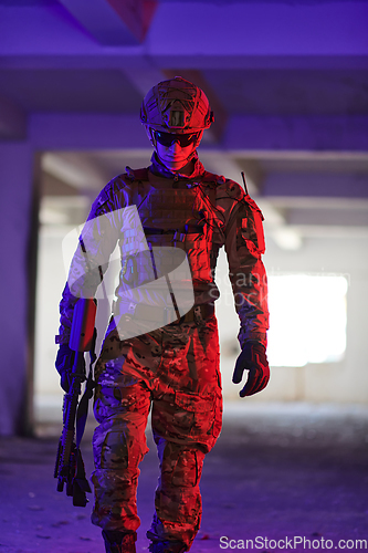 Image of A professional soldier undertakes a perilous mission in an abandoned building illuminated by neon blue and purple lights