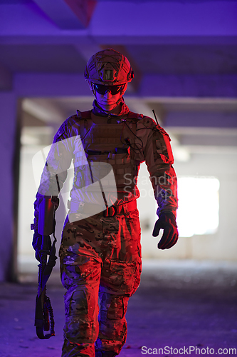 Image of A professional soldier undertakes a perilous mission in an abandoned building illuminated by neon blue and purple lights