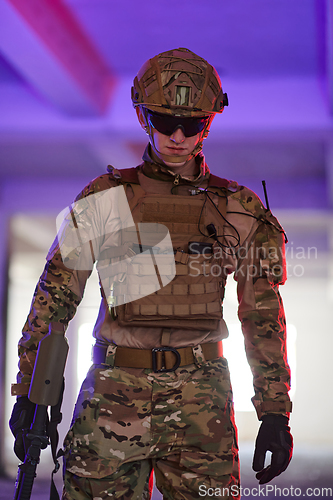 Image of A professional soldier undertakes a perilous mission in an abandoned building illuminated by neon blue and purple lights