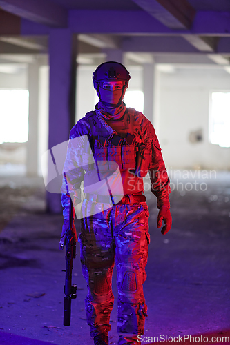 Image of A professional soldier undertakes a perilous mission in an abandoned building illuminated by neon blue and purple lights