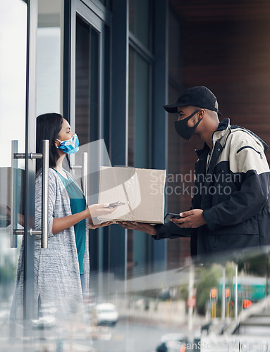 Image of We care for your safety so lets keep the distance. a masked young woman receiving a delivery at home.