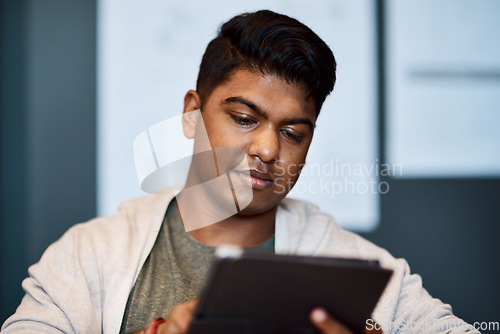 Image of The tool to get the design done quicker. a young businessman using a digital tablet in a modern office.