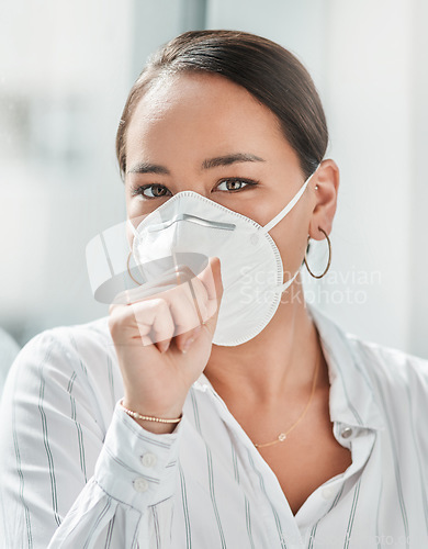 Image of Covering your mouth is more than just good manners. a masked young businesswoman coughing in a modern office.