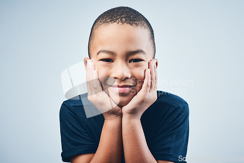 Image of First rule of being a kid Smile. Studio shot of a cute little boy posing against a grey background.