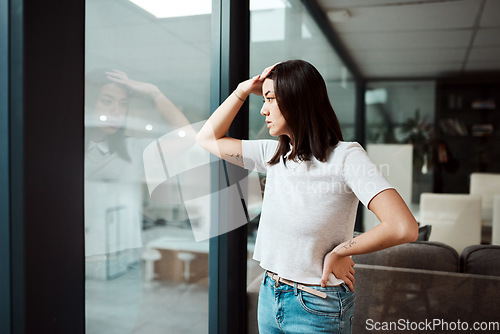 Image of Take a moment to breathe and maybe youll feel better. a young businesswoman looking stressed out in an office.