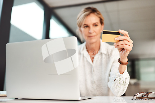 Image of Now you can manage your businesss money 247. a mature businesswoman using a laptop and credit card in an office.