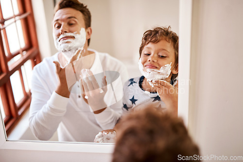 Image of Heres how dad manages to look ten years younger. a man teaching his young son how to shave at home.