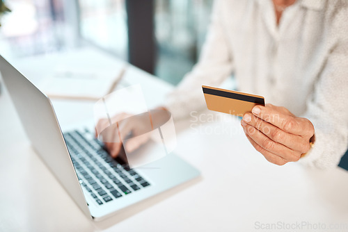 Image of Transacting through her business banking profile. Closeup shot of an unrecognisable businesswoman using a laptop and credit card in an office.