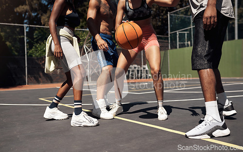 Image of Basketball is all about balance and coordination. Closeup shot of a group of sporty young people playing basketball on a sports court.