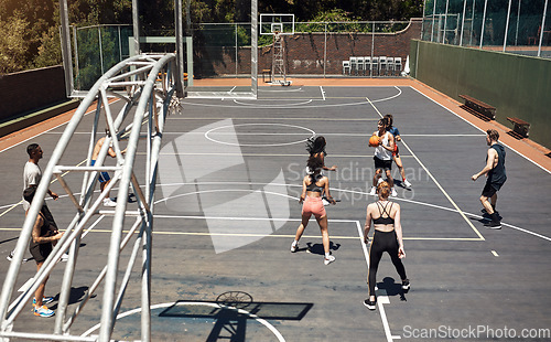 Image of The pros are at play. a group of sporty young people playing basketball on a sports court.