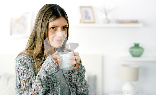 Image of All you need is some free time and coffee. a woman enjoying a cup of coffee at home.