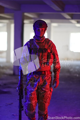 Image of A professional soldier undertakes a perilous mission in an abandoned building illuminated by neon blue and purple lights