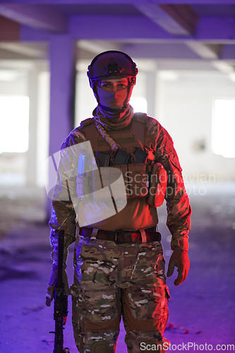 Image of A professional soldier undertakes a perilous mission in an abandoned building illuminated by neon blue and purple lights