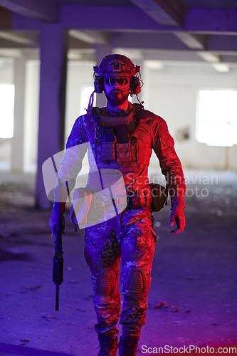 Image of A professional soldier undertakes a perilous mission in an abandoned building illuminated by neon blue and purple lights