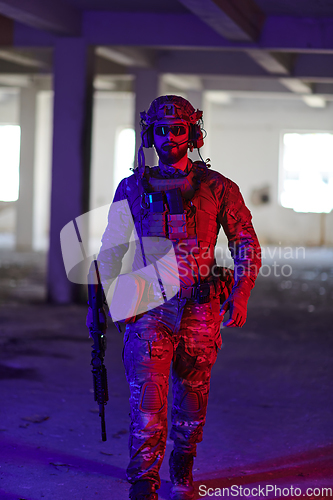 Image of A professional soldier undertakes a perilous mission in an abandoned building illuminated by neon blue and purple lights