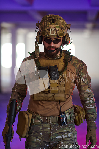 Image of A professional soldier undertakes a perilous mission in an abandoned building illuminated by neon blue and purple lights