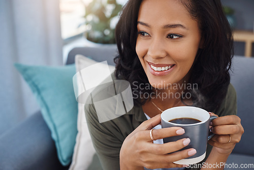Image of I really need to do more of this. an attractive young woman having coffee and relaxing on the sofa at home.