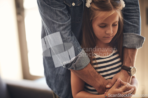 Image of Love will keep the blues away. an adorable little girl looking sad and being comforted by her father at home.